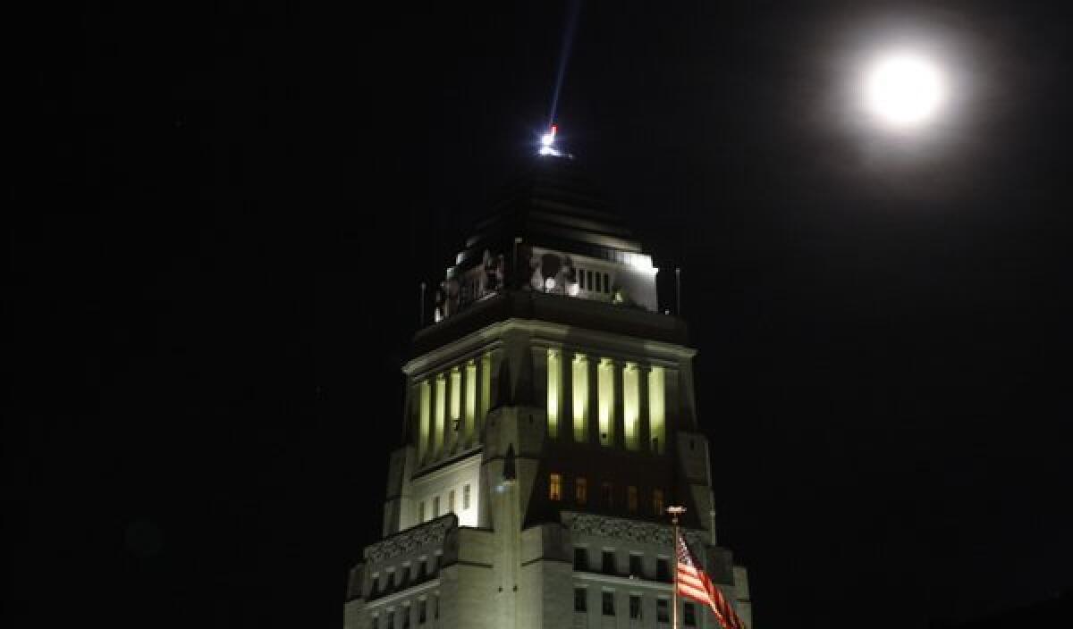 One kind of blue moon, the second in one calendar month, rises over Los Angeles City Hall on Dec. 31, 2009. A different kind of blue moon rose Tuesday night.
