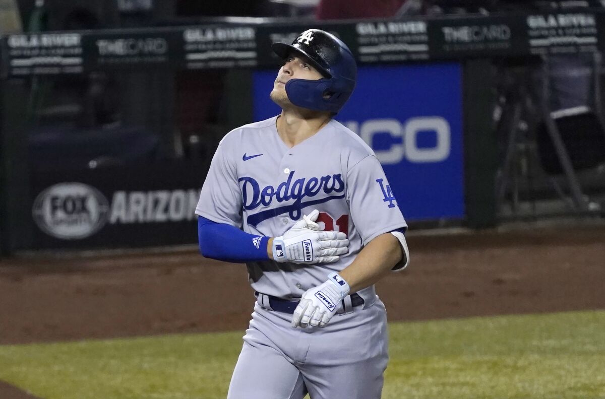 Los Angeles Dodgers' Kiké Hernandez touches the jersey No. 21.