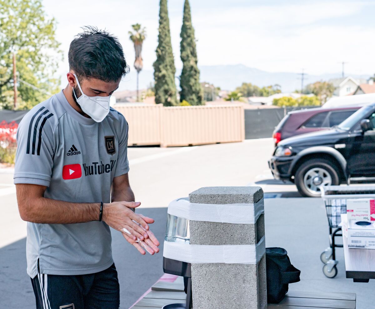 LAFC forward Diego Rossi uses some hand sanitizer during a team training session on Thursday.