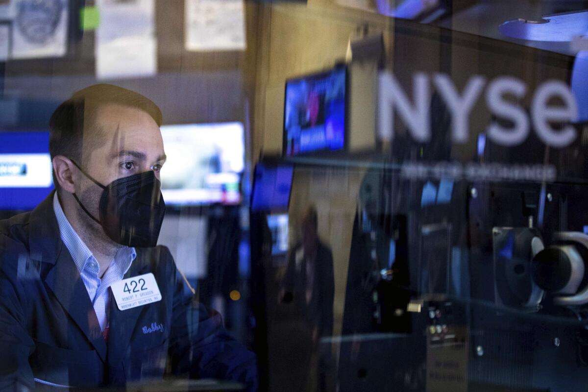 In this photo provided by the New York Stock Exchange, trader Robert Greason works on the floor, Friday, June 3, 2022. U.S. stocks are falling Friday as Wall Street focuses on the downside of the still-strong U.S. jobs market. (Allie Joseph/New York Stock Exchange via AP)