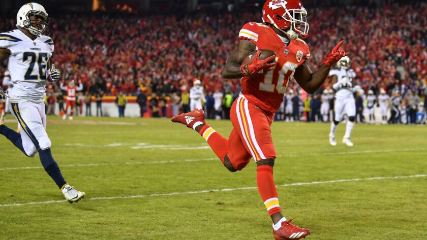Wide receiver Tyreek Hill of the Kansas City Chiefs runs to the end zone after beating Chargers cornerback Casey Hayward (left) for a long touchdown Saturday night in Kansas City, Mo.