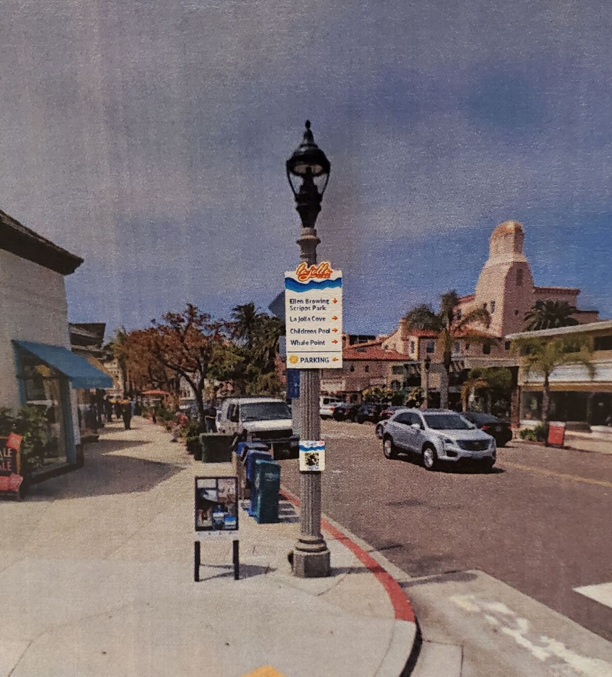 A rendering shows a directional sign superimposed on a lamppost.