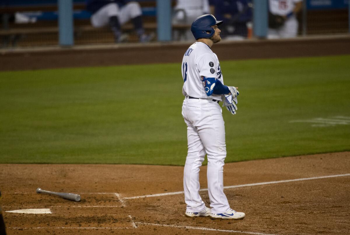 Dodgers first baseman Max Muncy stands at home plate after striking out.
