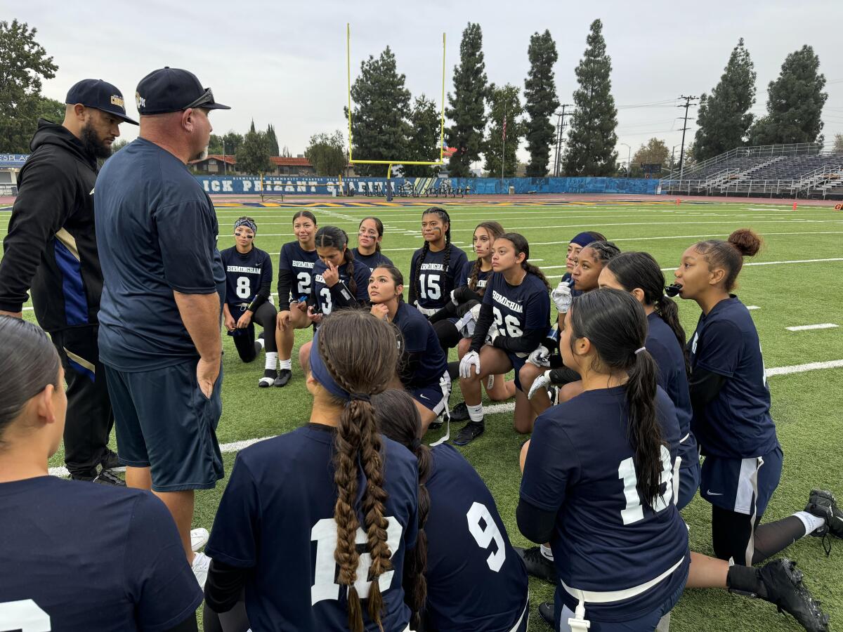 Birmingham flag football coach Jim Rose addresses his players after a 32-0 win 