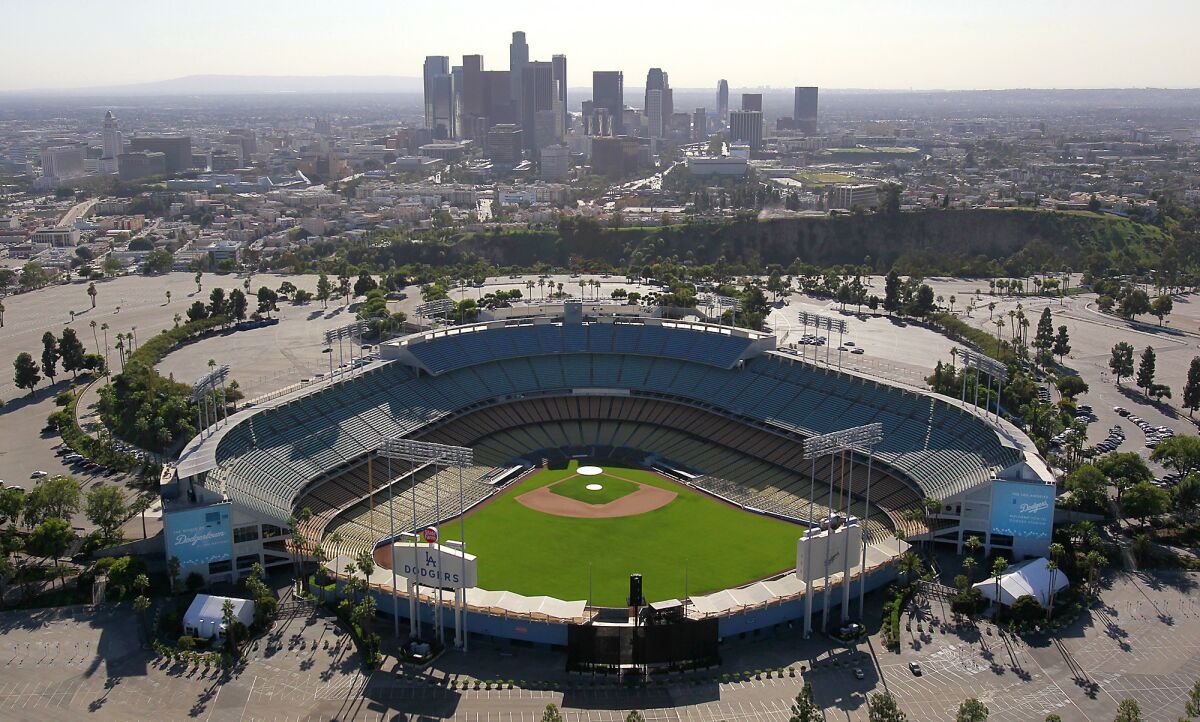An aerial view of L.A.'s Dodger Stadium and vast parking lot.