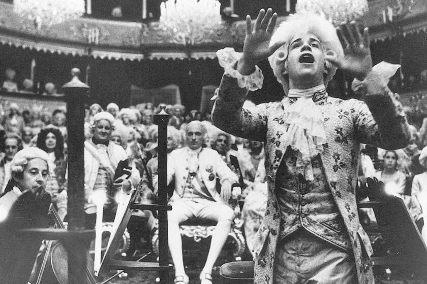Tom Hulce, right, as Wolfgang Amadeus Mozart in the movie AMADEUS, directed by Milos Forman. ourtesy Orion Pictures. photo by Phil Bray. SUNDAY JUNE 2 MOVIE PAGE