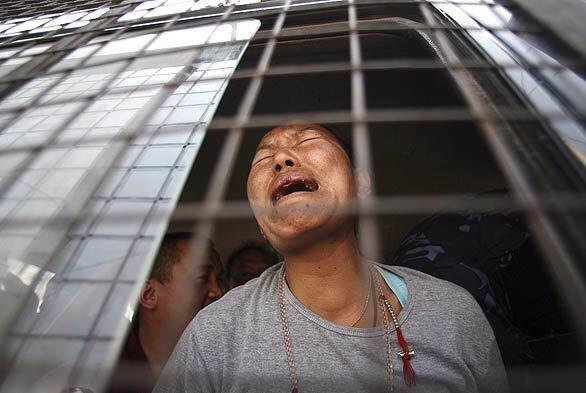 It was another week of grief and tension for Tibetans around the world, including this woman inside a police van after authorities dispersed protesters in Katmandu, Nepal. Eleven members of Amnesty International were among those detained.