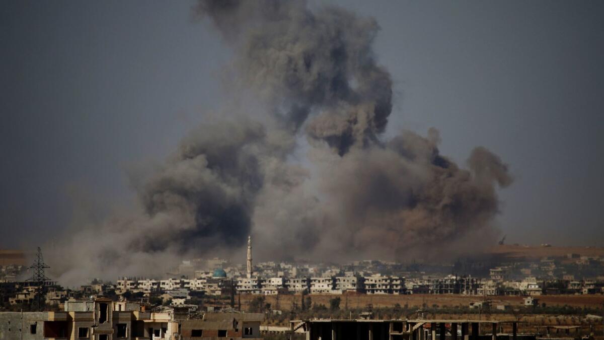 Smoke rises above a rebel-held town east of the city of Dara during airstrikes by Syrian government forces on June 30, 2018.