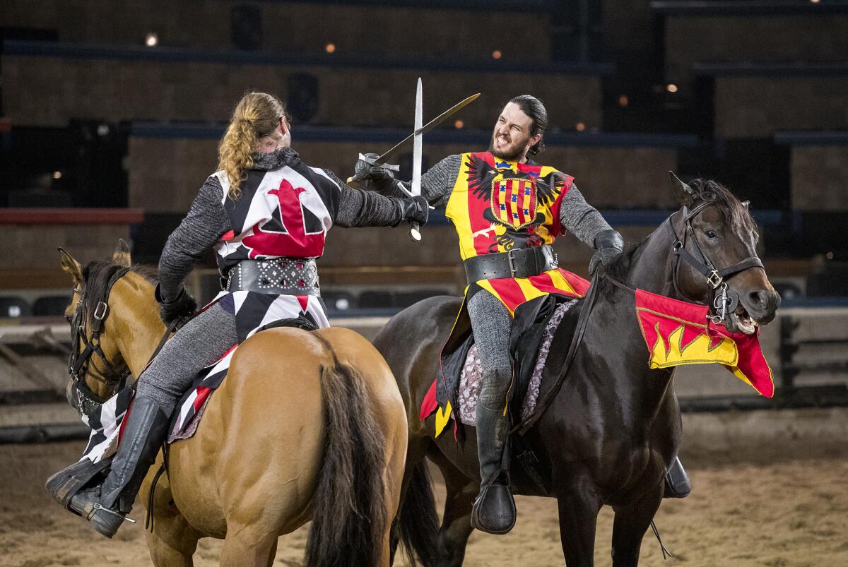 Phil La Croix, left, as Iofre Santa Creu, and Zack Synder, as Lord Del Font, rehearse a fight scene at Medieval Times in Buena Park on Wednesday, March 14. Inspire charter schools have informed parents that, as of Aug. 1, they can no longer use school enrichment funds to buy dinner theater tickets.