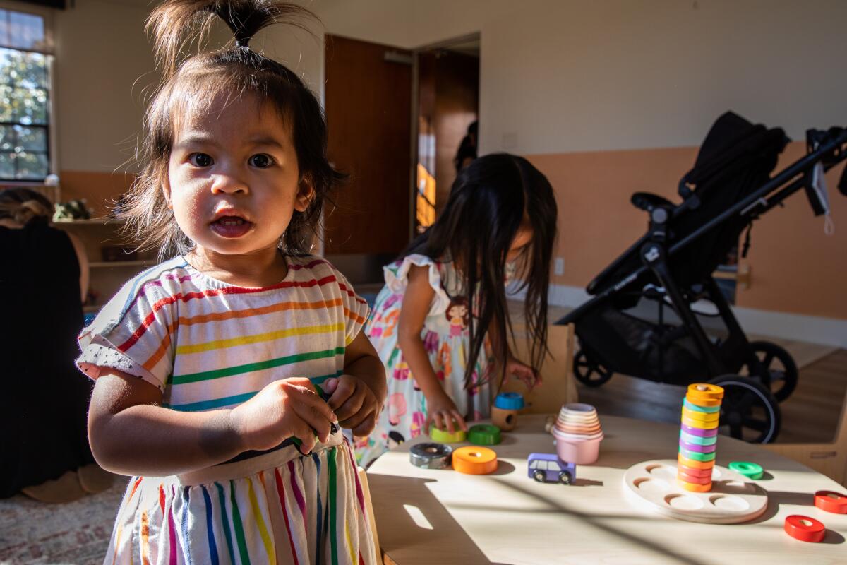 Kiran Esguerra (left) and Logan Esguerra (right) play with toys at The New Haven.