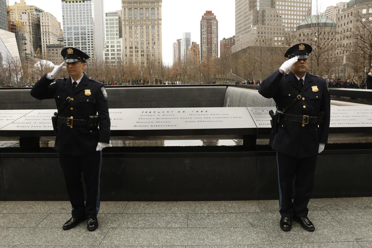 Officers salute during a memorial ceremony held on the 25th anniversary of the 1993 World Trade Center bombing.
