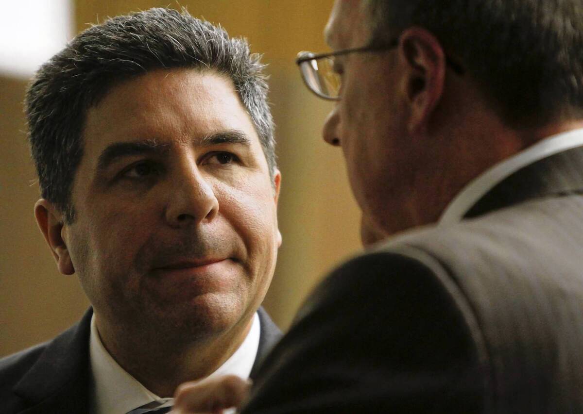 Santa Ana City Councilman Carlos Bustamante, left, makes his first court appearance Thursday with his attorney, James Riddet. Bustamante is accused of sexually assaulting women while he worked as an Orange County administrator.