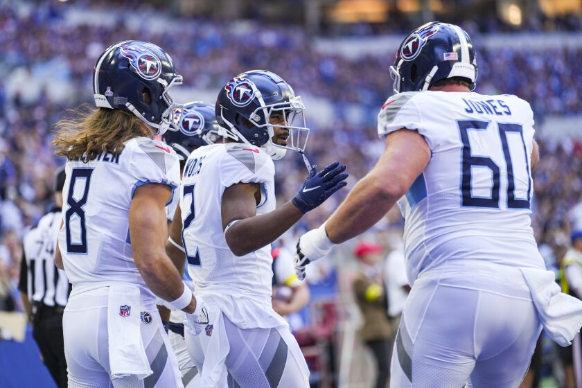 Tennessee Titans wide receiver Robert Woods (2) celebrates a touchdown with wide receiver Cody Hollister and center Ben Jones in the first half of an NFL football game in Indianapolis, Fla., Sunday, Oct. 2, 2022. (AP Photo/AJ Mast)