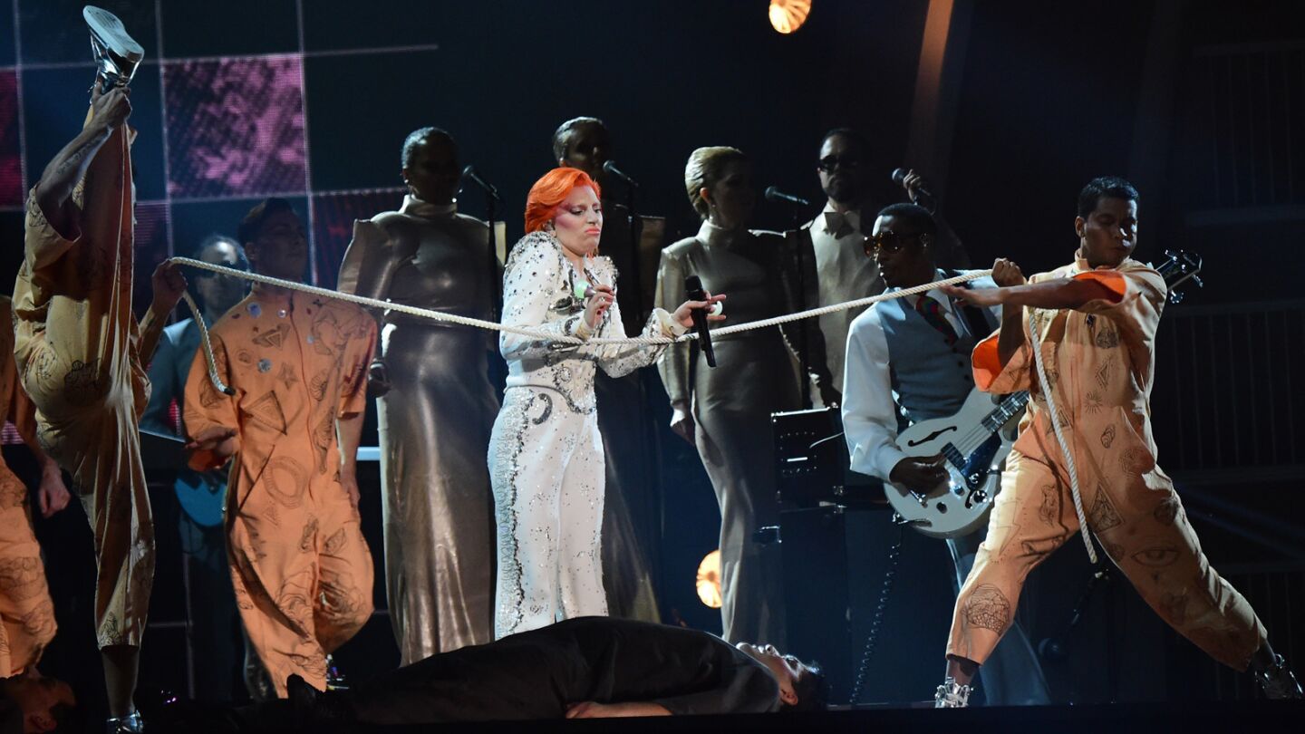 Lady Gaga pays tribute to David Bowie by singing nearly half a dozen of his songs, including "Space Oddity," "Rebel Rebel" and "Under Pressure."