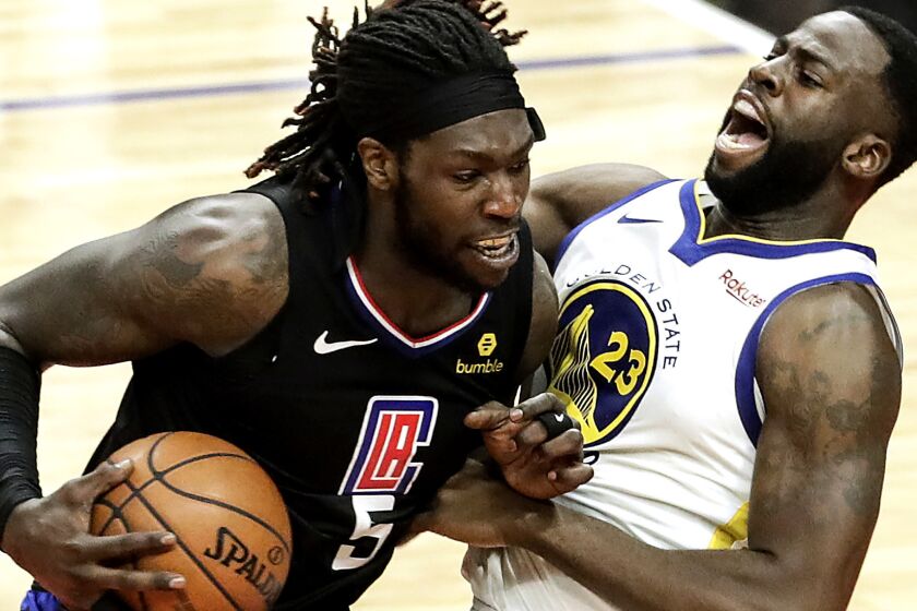 LOS ANGELES, CA, SUNDAY, APRIL 21, 2019 - Clippers center Montrezl Harrell charges into Warriors forward Draymond Green during fourth quarter action in game four of the first round of the NBA Western Conference Playoffs at Staples Center. (Robert Gauthier/Los Angeles Times)