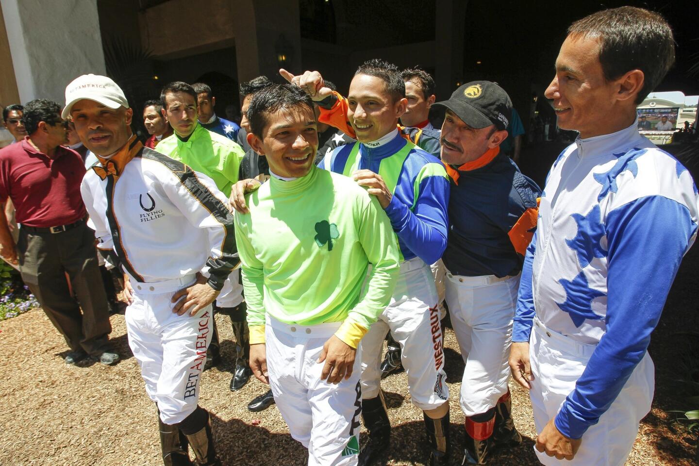 Jockeys gather before entering the Paddock area for a group photo.