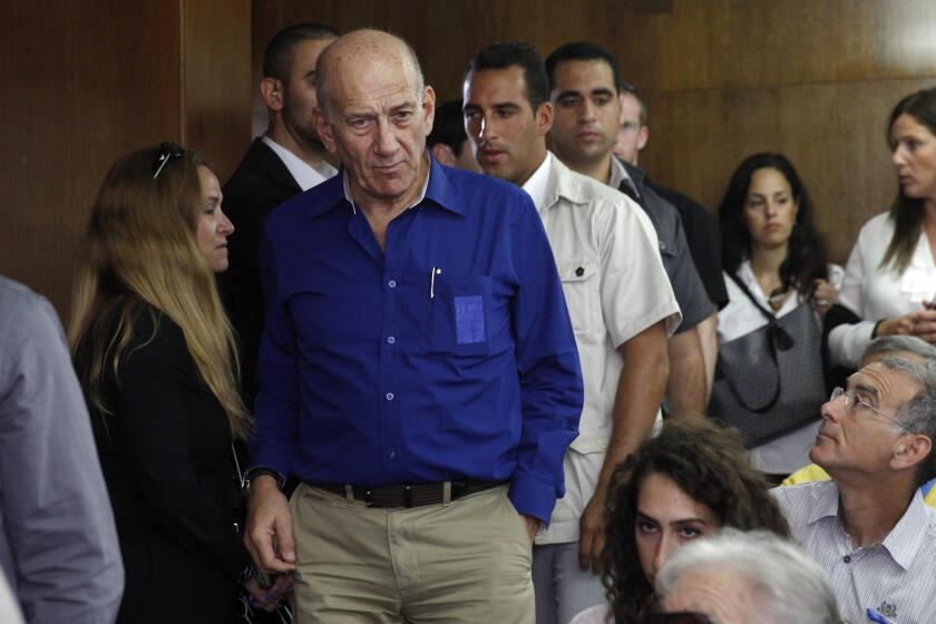 Ehud Olmert stands at the Tel Aviv District Court on May 13, 2014.