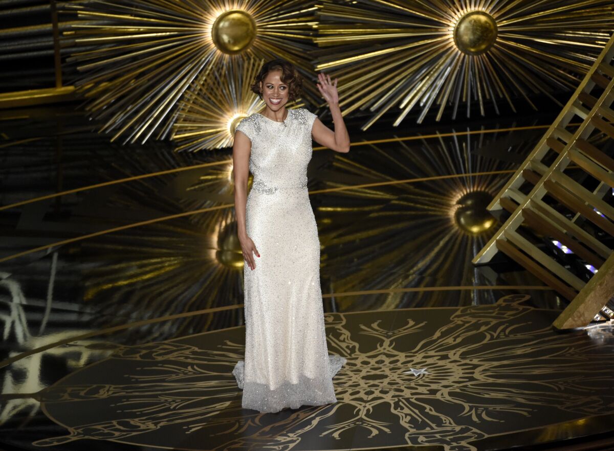 Outspoken conservative Stacey Dash onstage at the Oscars after being introduced by host Chris Rock as "director of minority outreach."