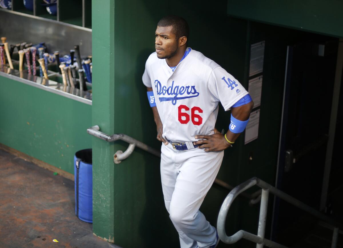 Dodgers right fielder Yasiel Puig walks into the dugout before a game against the Pittsburgh Pirates on June 24.