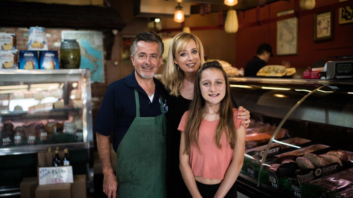 George Viola, owner of Hacienda Village Meats & Italian Deli, with his wife, Silvia. and daughter Giovanna, who both help out at the store.