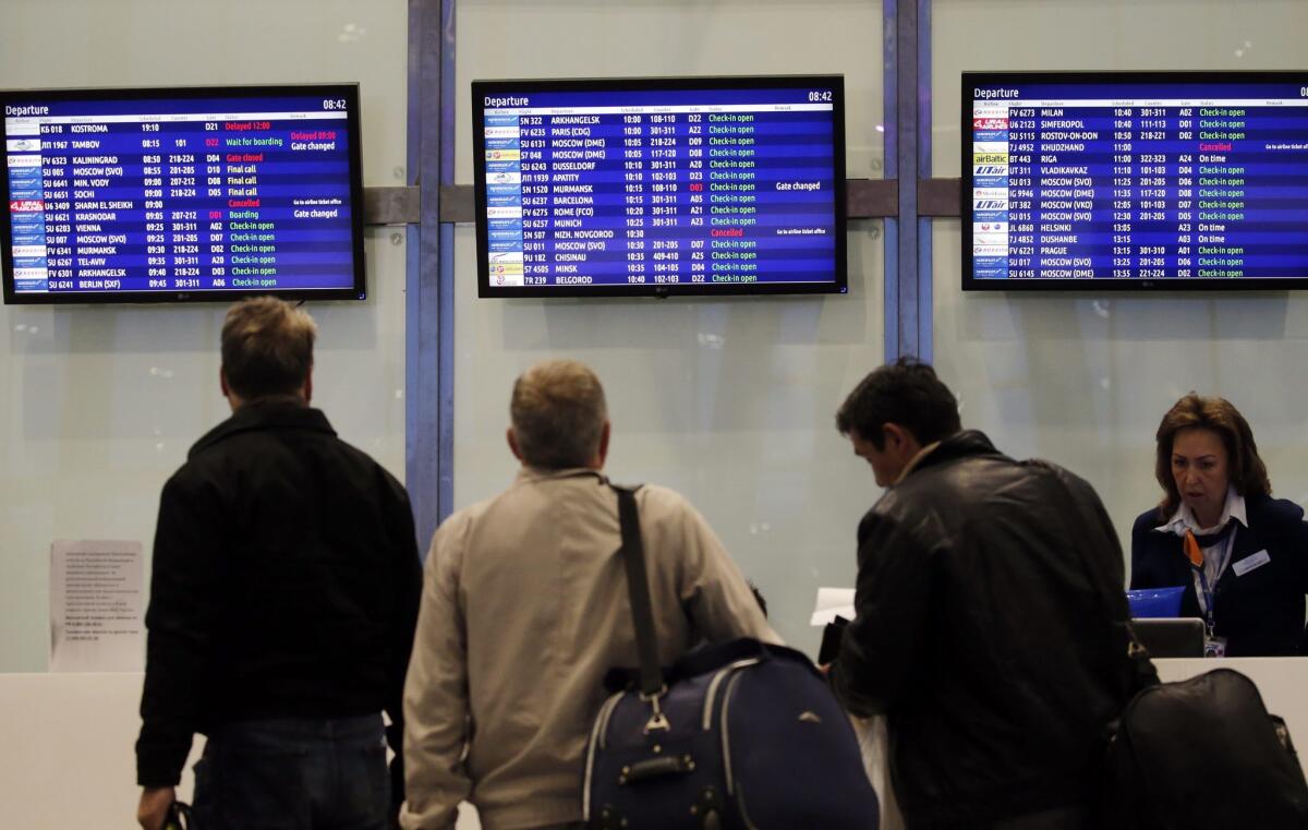 Passengers check monitors as flights to Sharm el Sheik appear as canceled at Pulkovo airport in St. Petersburg, Russia, on Saturday.