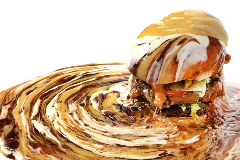 A burger drenched in condiments