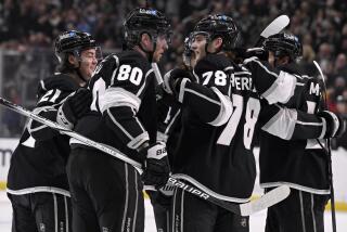 Kings forward Pierre-Luc Dubois celebrates with teammates and scoring against the Oilers.