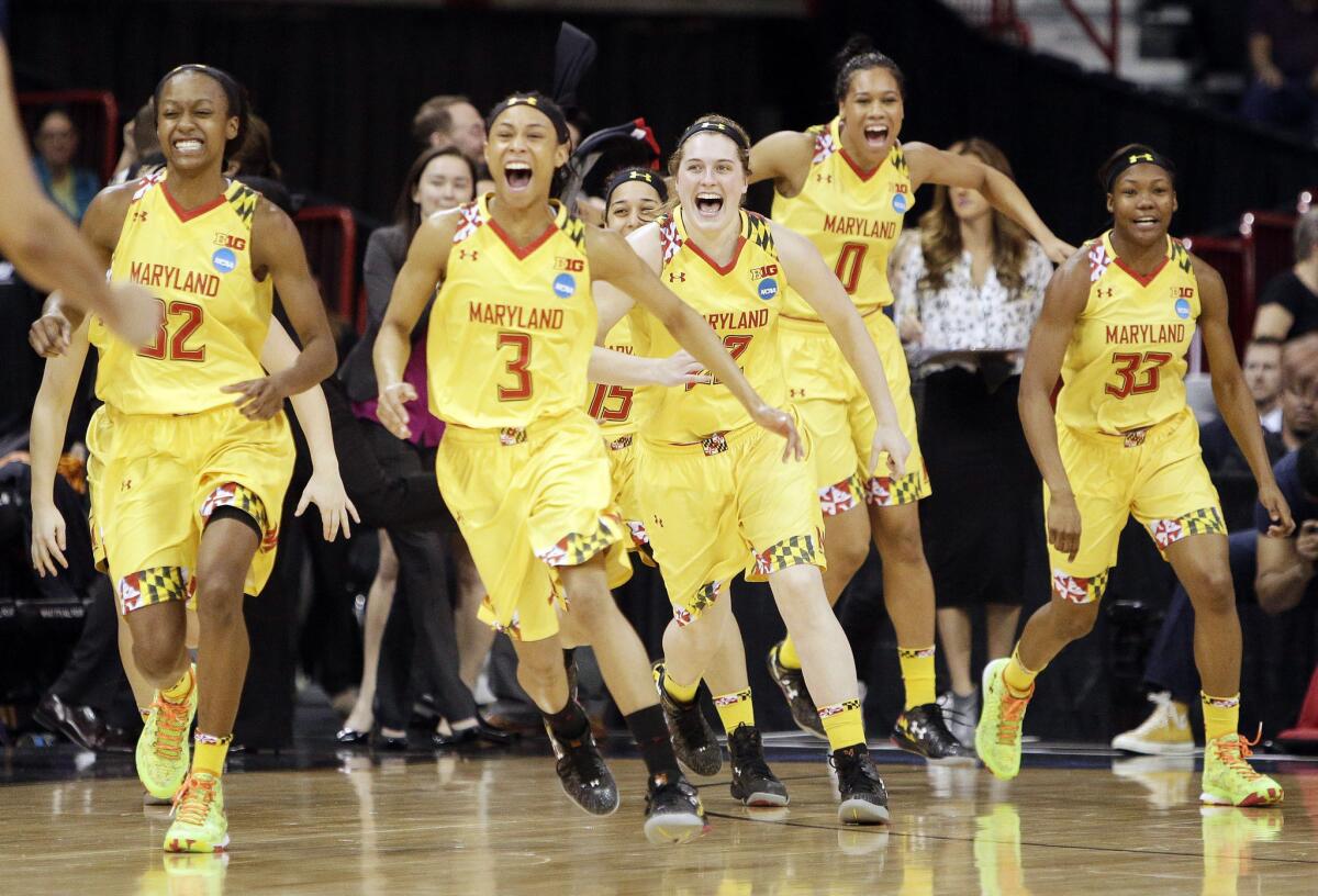 Maryland women's basketball players run to celebrate after defeating Tennessee in the regional final to earn a trip to the Final Four.