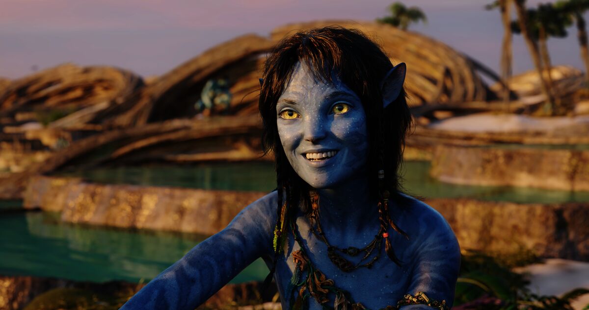 A blue teenage Na'vi-human character in a scene from "Avatar: The Way of Water."