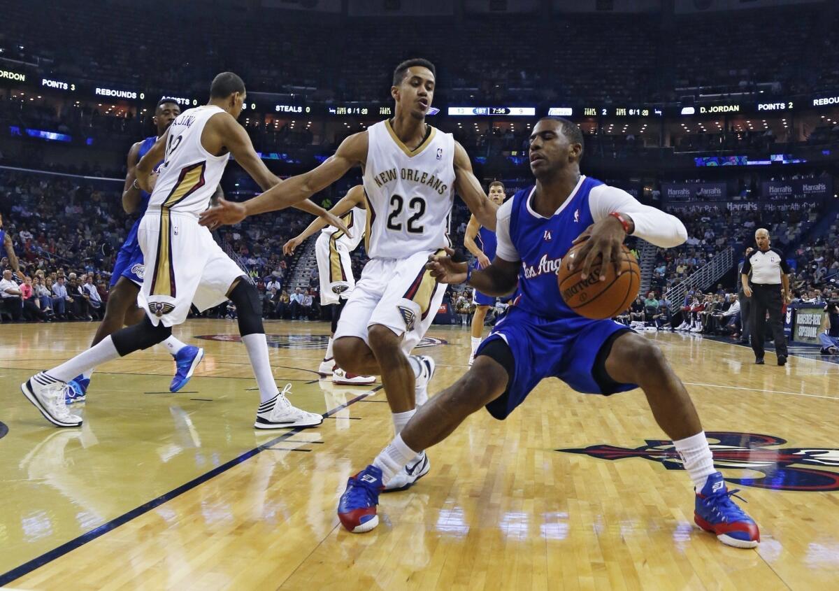 Clippers point guard Chris Paul drives against Pelicans guard Brian Roberts during a game earlier this season.