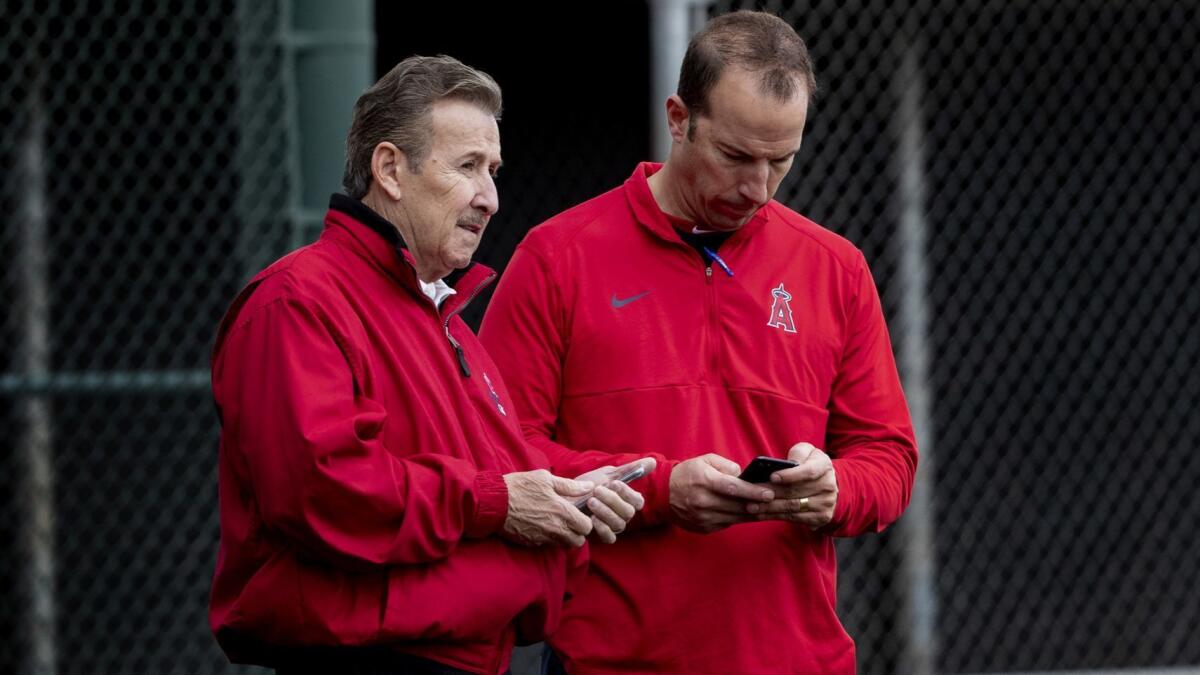General manager Billy Eppler, right, will be looking to draft another keeper for owner Arte Moreno and the Angels on Monday.