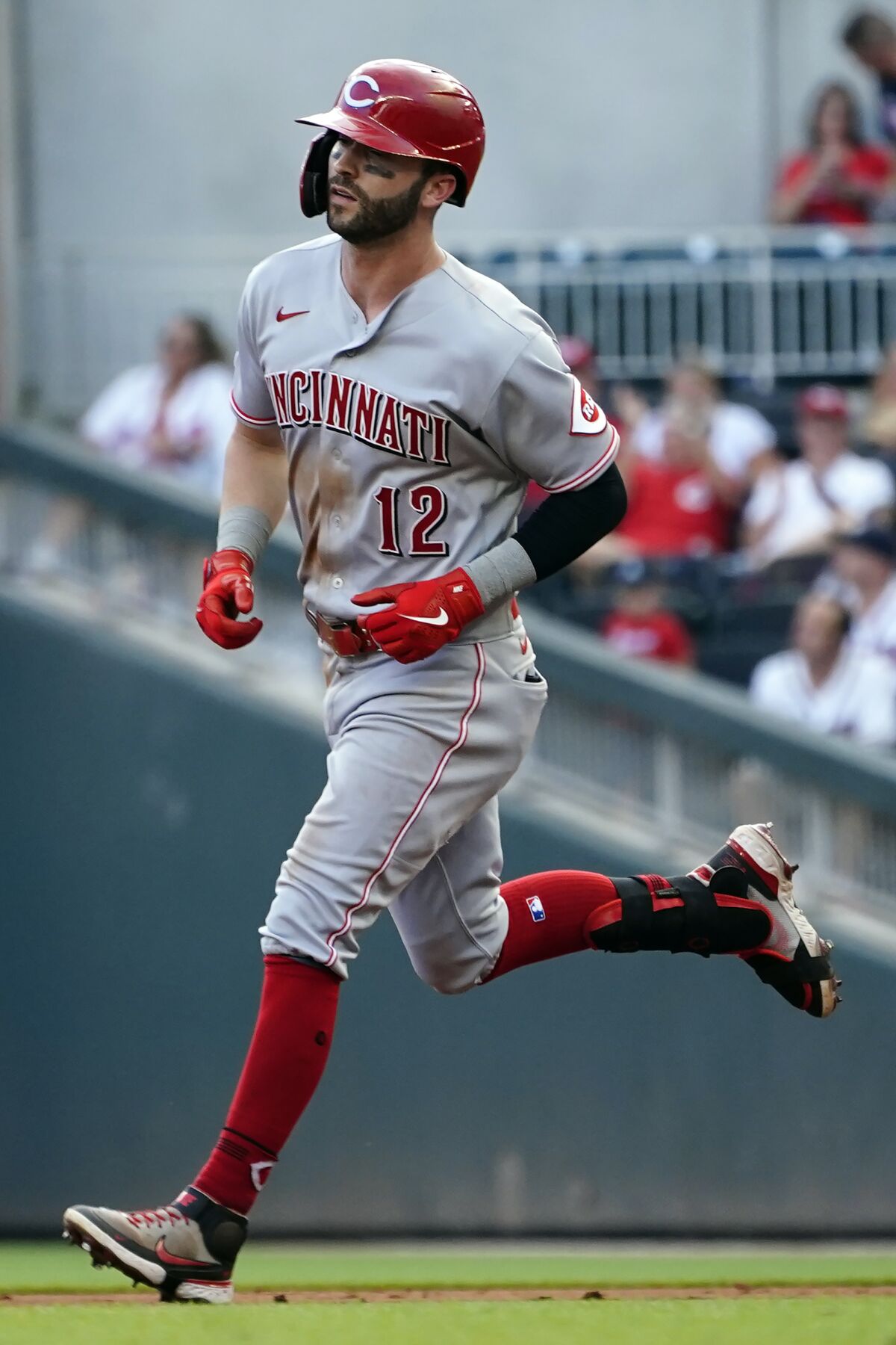 Cincinnati Reds' Tyler Naquin runs the bases after hitting a three-run home run during the third inning of the team's baseball game against the Atlanta Braves on Thursday, Aug. 12, 2021, in Atlanta. (AP Photo/John Bazemore)