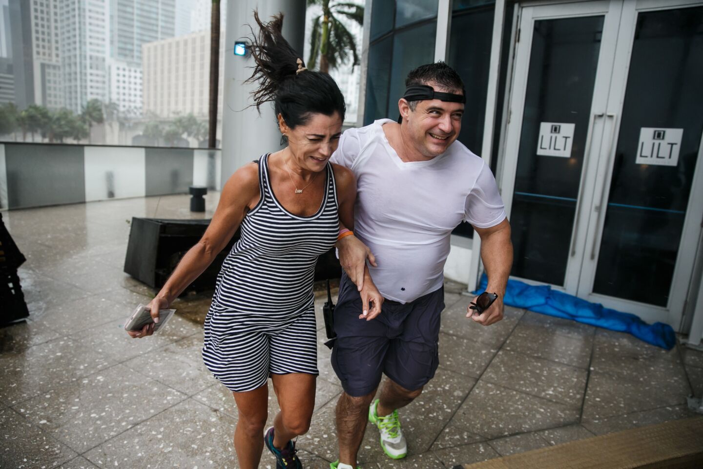 A man and woman run to safety in Miami as winds from Hurricane Irma bear down on Sunday.