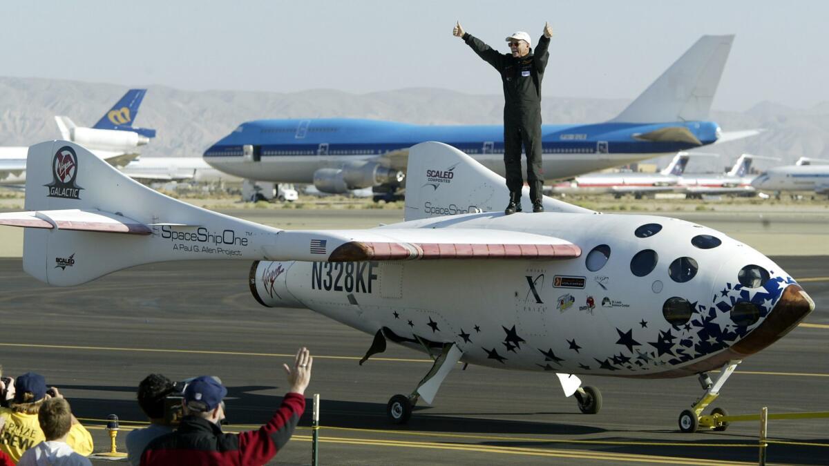 Commerical astronaut Michael Mevill gives the thumbs-up atop SpaceShipOne after his team's first space flight in the two-flight contest for the $10-million Ansari X Prize in September 2004.