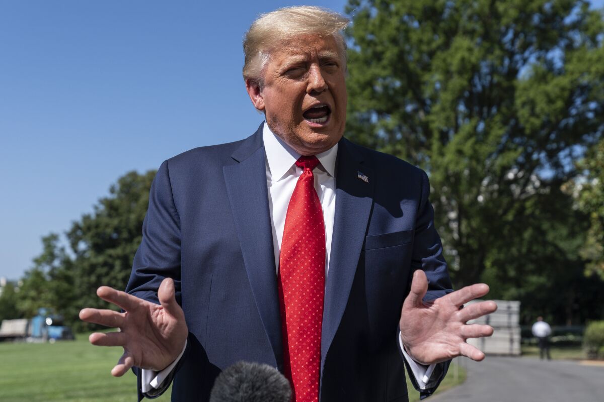 President Donald Trump speaks with reporters as he walks to Marine One on the South Lawn of the White House, Monday, Aug. 17, 2020, in Washington. Trump is en route to Minnesota and Wisconsin. (AP Photo/Alex Brandon)