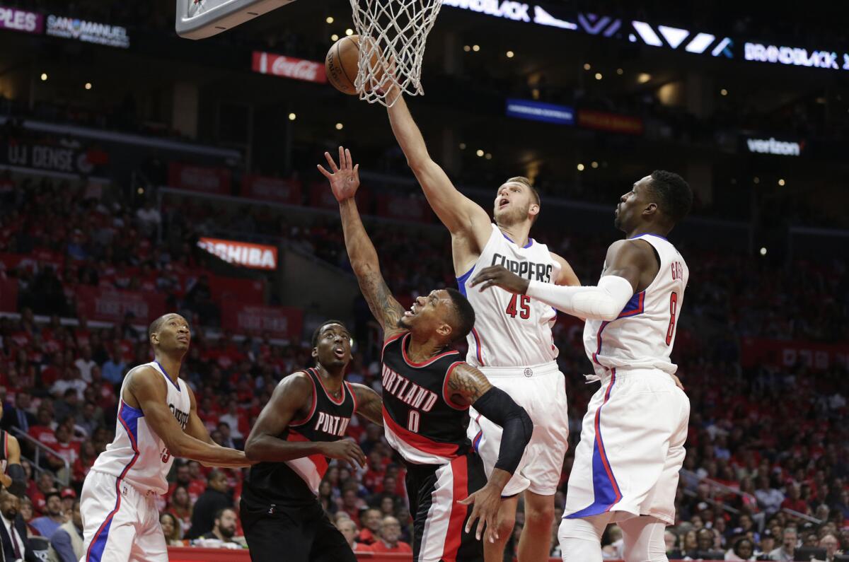Clippers center Cole Aldrich blocks the shot of Trail Blazers forward Meyers Leonard during the second half of Game 2.
