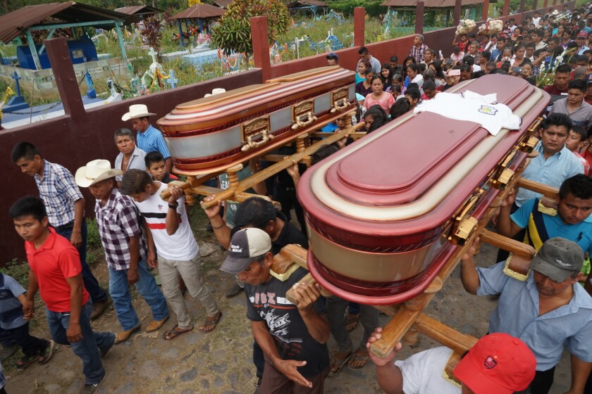 The caskets of Delfino Cash Lopez, 19, and Felix Cash Lopez, 17, are carried from their home in Aldea Nica, Guatemala. The cousins and other migrants died in a March 7 truck accident in Chiapas, Mexico.