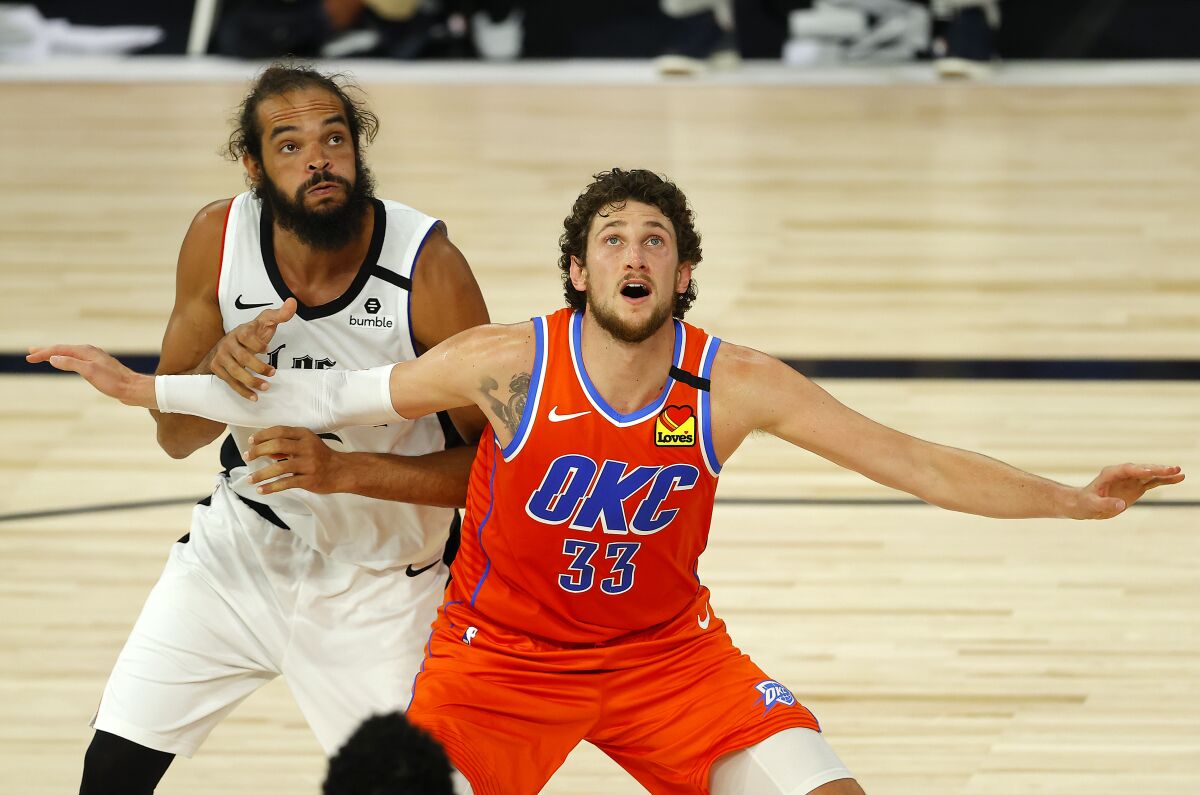 Oklahoma City Thunder's Mike Muscala (33) and Los Angeles Clippers' Joakim Noah, left, battle for position during the third quarter of an NBA basketball game Friday, Aug. 14, 2020, in Lake Buena Vista, Fla. (Mike Ehrmann/Pool Photo via AP)