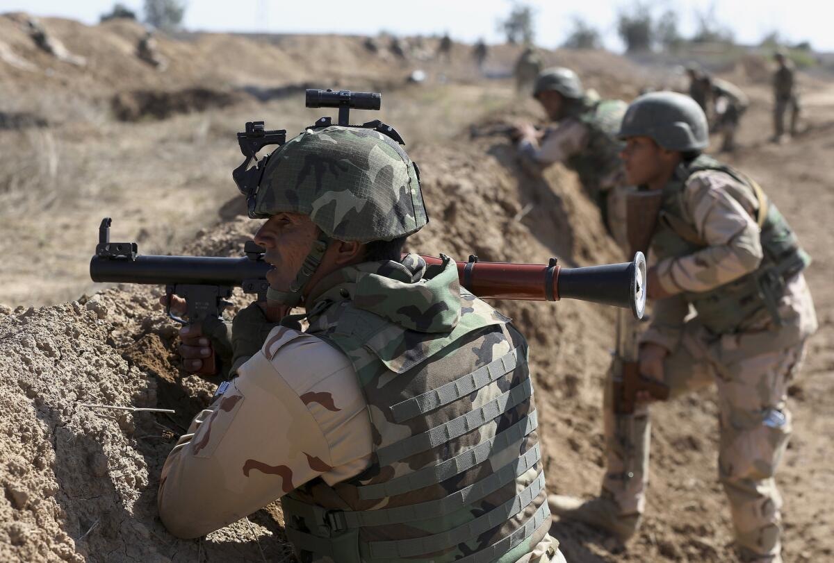Iraqi security forces participate in a drill as U.S. forces train them in Taji, north of Baghdad, Iraq, in 2015.