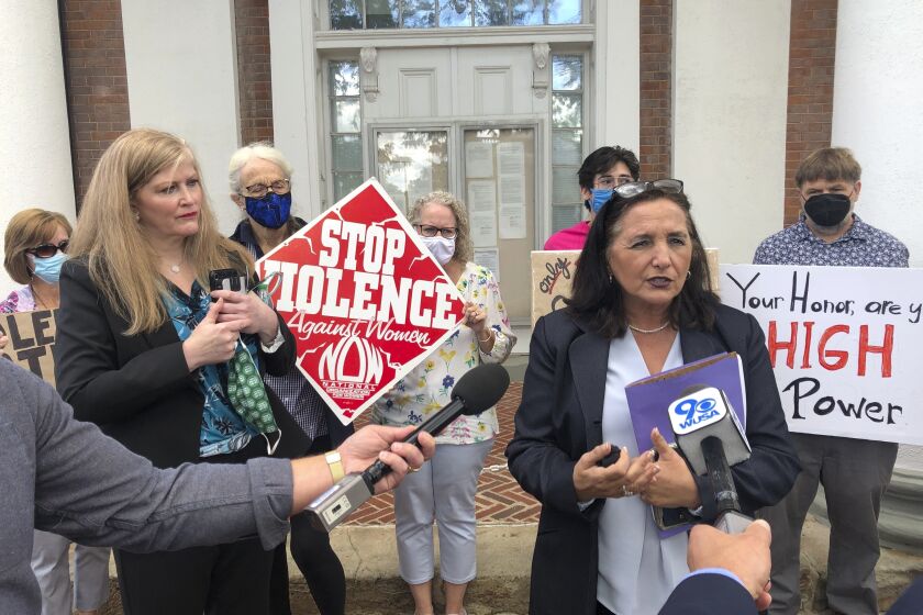 FILE - Loudoun County, Va., Commonwealth's Attorney Buta Biberaj, right, speaks to media on Sept. 23, 2021, in Leesburg, Va. On Thursday, Dec. 8, 2022, the Virginia Supreme Court reinstated Biberaj, a progressive prosecutor on a criminal burglary case, after a judge removed her when he was dissatisfied with a plea deal her office reached. (AP Photo/Matthew Barakat, File)