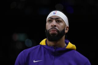 Los Angeles Lakers' Anthony Davis stands on the court during warmups.