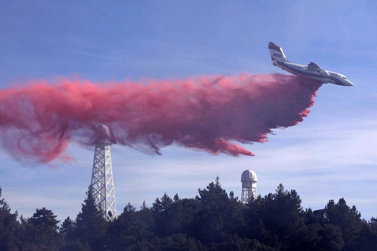 An air tanker drops fire retardant over the Mt. Wilson Observatory as firefighters work to extinguish a fire in the Angeles National Forest.