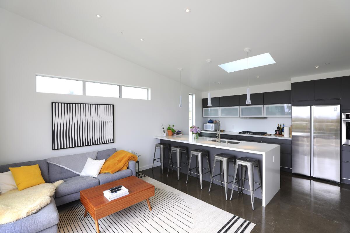 The contemporary open-plan design carries into the upstairs ADU, which has two bedrooms and two bathrooms.