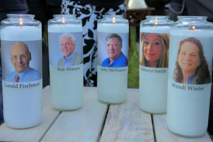 Candles honoring Gerald Fischman, Rob Hiassen, John McNamara, Rebecca Smith, and Wendi Winters flicker as the sun sets during a candlelight vigil on Friday, June 29, 2018, at Annapolis Mall for the five Capital Gazette employees slain during a shooting spree in their newsroom. (Karl Merton Ferron/Baltimore Sun/TNS) ** OUTS - ELSENT, FPG, TCN - OUTS **