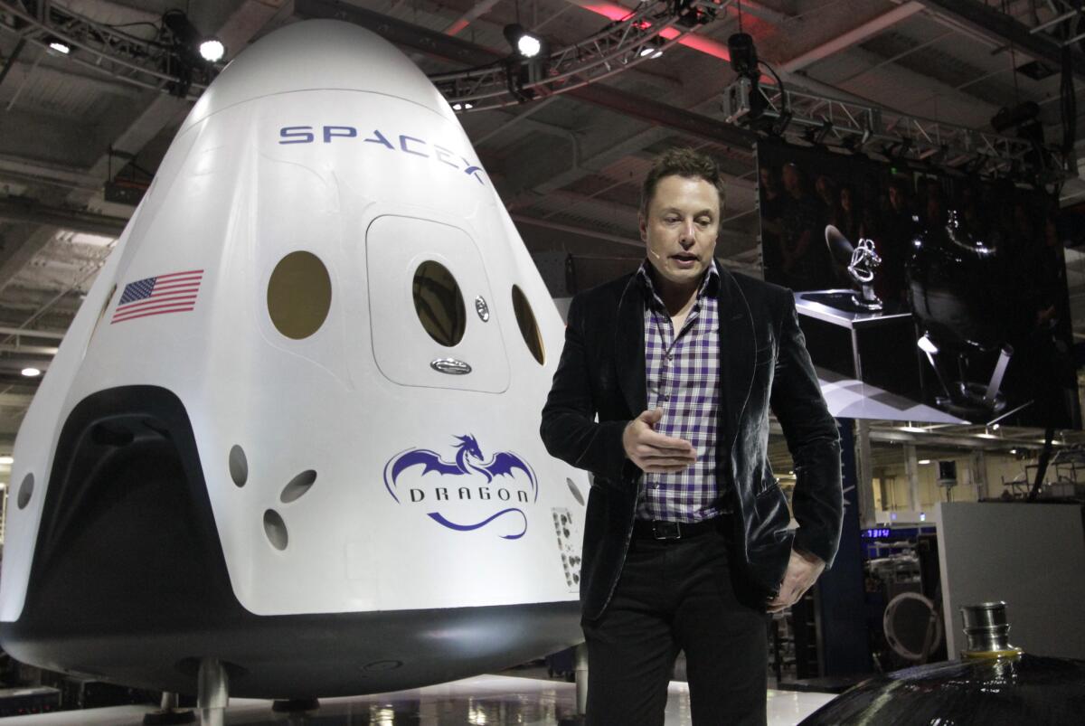 SpaceX Chief Executive Elon Musk introduces the Dragon V2 at the company's Hawthorne facility in May. The Dragon V2 is intended to carry astronauts into space.