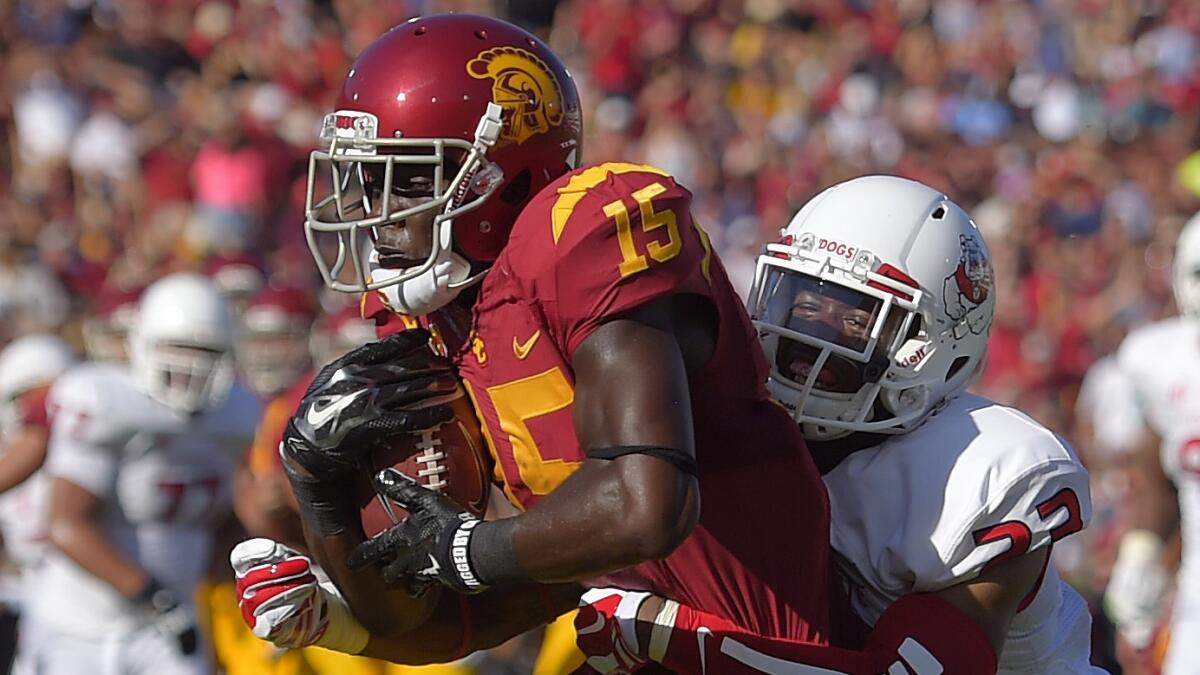 USC wide receiver Nelson Agholor, left, scores as Fresno State defensive back Bryan Harper defends during the first half of the Trojans' 52-13 victory Saturday. USC will face a tougher challenge against Stanford this week.