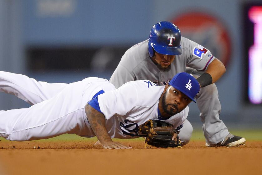 Texas second baseman Rougned Odor is forced out by Dodgers second baseman Howie Kendrick as he turns a double-play during the seventh inning of a game Wednesday at Dodger Stadium.