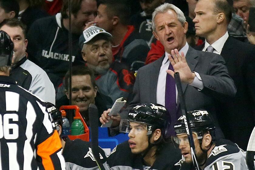 Coach Darryl Sutter talks with referee Dean Morton after the Kings had a goal disallowed.