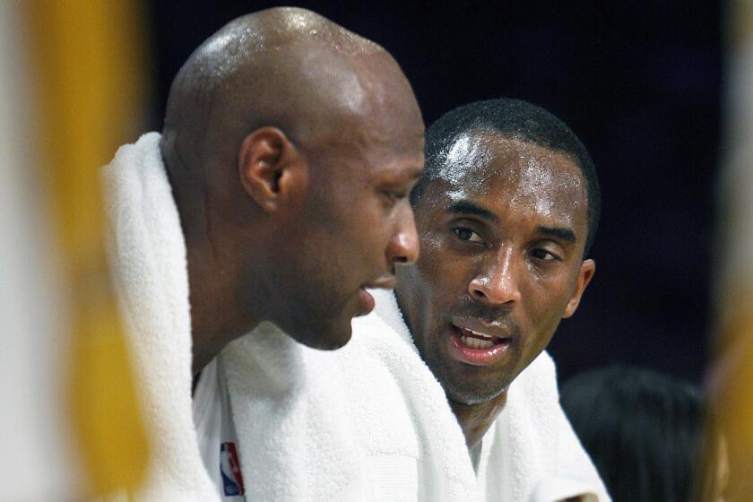 Lakers forward Lamar Odom, left, and guard Kobe Bryant talk on the bench during a timeout against the New Jersey Nets on Nov. 26, 2006.