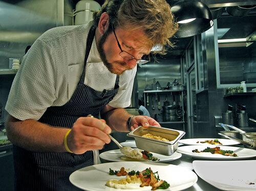 Chef/owner Michael Cimarusti plates food in the kitchen of Providence.